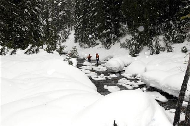 Pierce County Swiftwater Rescue Team members stand in a creek at Mount Rainier National Park in Washington state, at spot where they found gun carried by Benjamin Colton Barnes; Barnes was found further down the creek